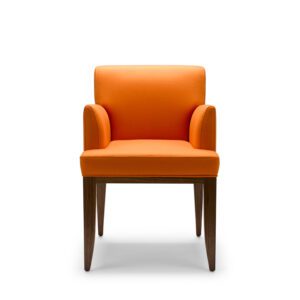 Shown here upholstered in Pumpkin orange wool, with legs in natural oiled walnut.