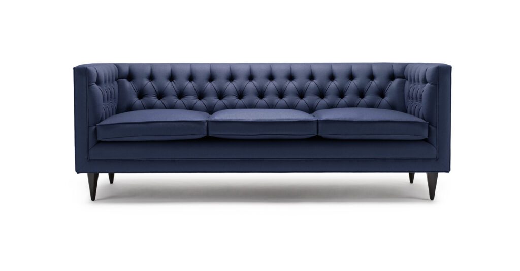 The Tux Lux sofa - Shown here upholstered in Holland & Sherry navy wool felt, with legs in black lacquered walnut.