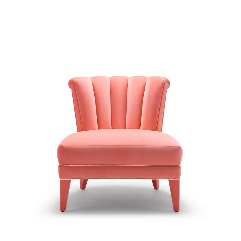 Isabella Occasional Chair shown in a bright coral colour with melon piping. It has a fluted back.